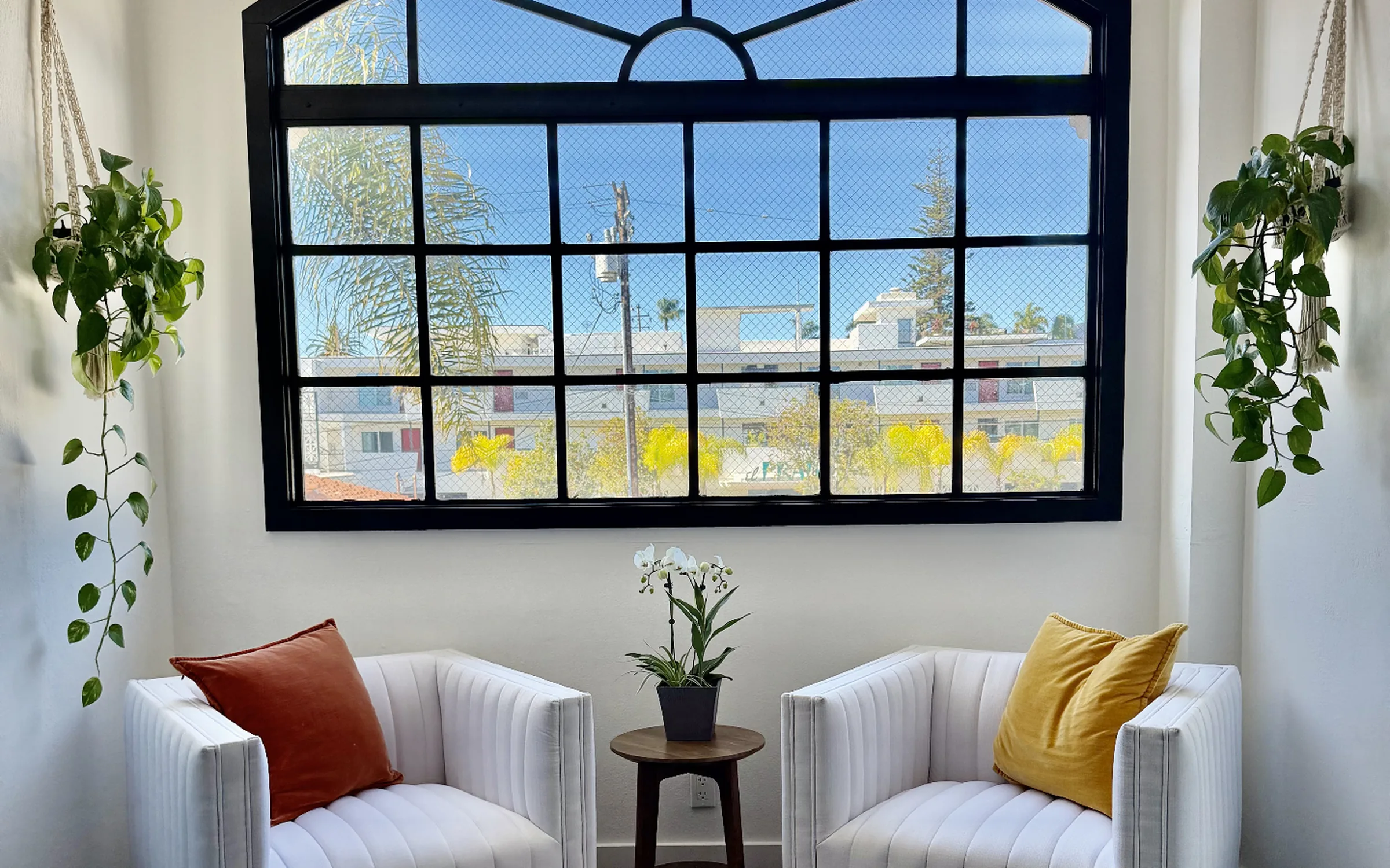 Kërfree Aesthetics consultation lounge with arched window and armchairs